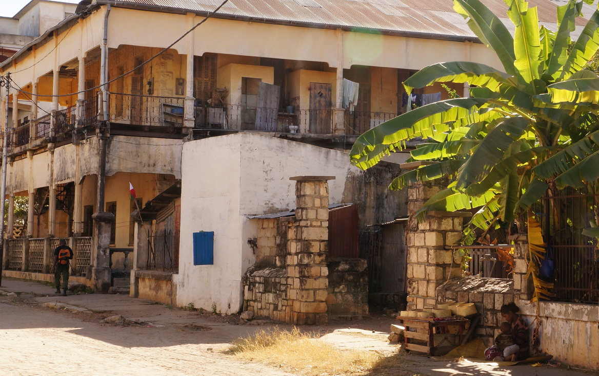 Woman vendor with kid outside building