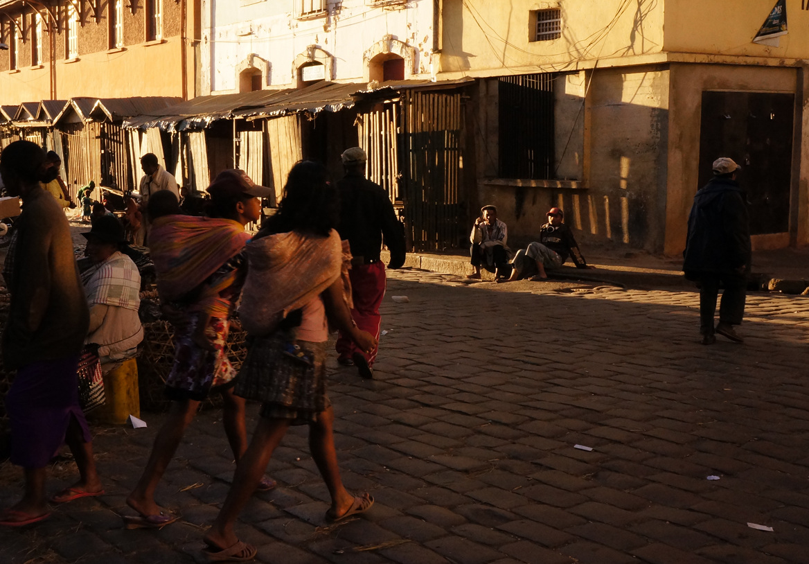 Antananarivo - two girls striding with papooses