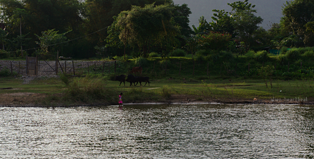 Laos: girl playing in river